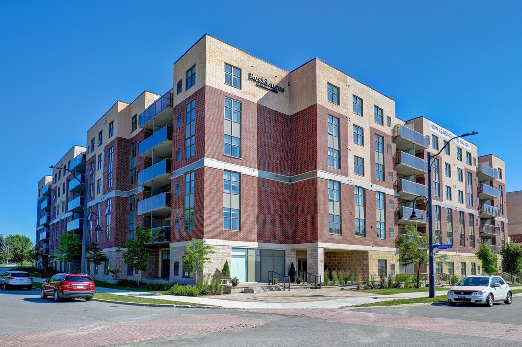 a brick apartment building on the corner of a city street