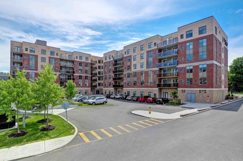 a view of a large apartment building with a parking lot