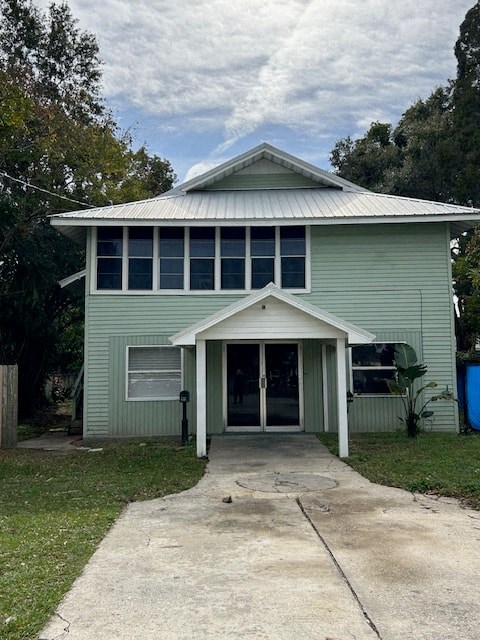 a green house with a walkway in front of it