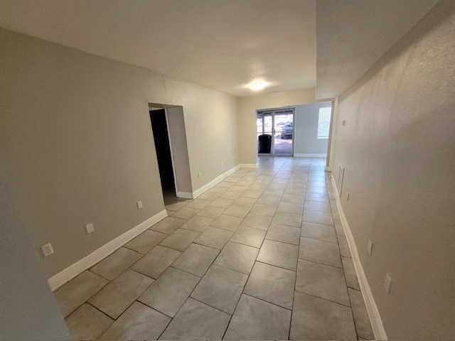 a large empty room with a tiled floor