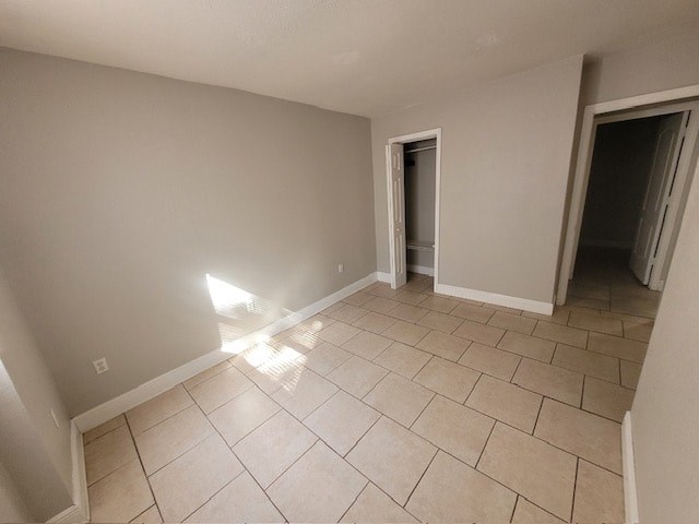 a empty living room with a tiled floor