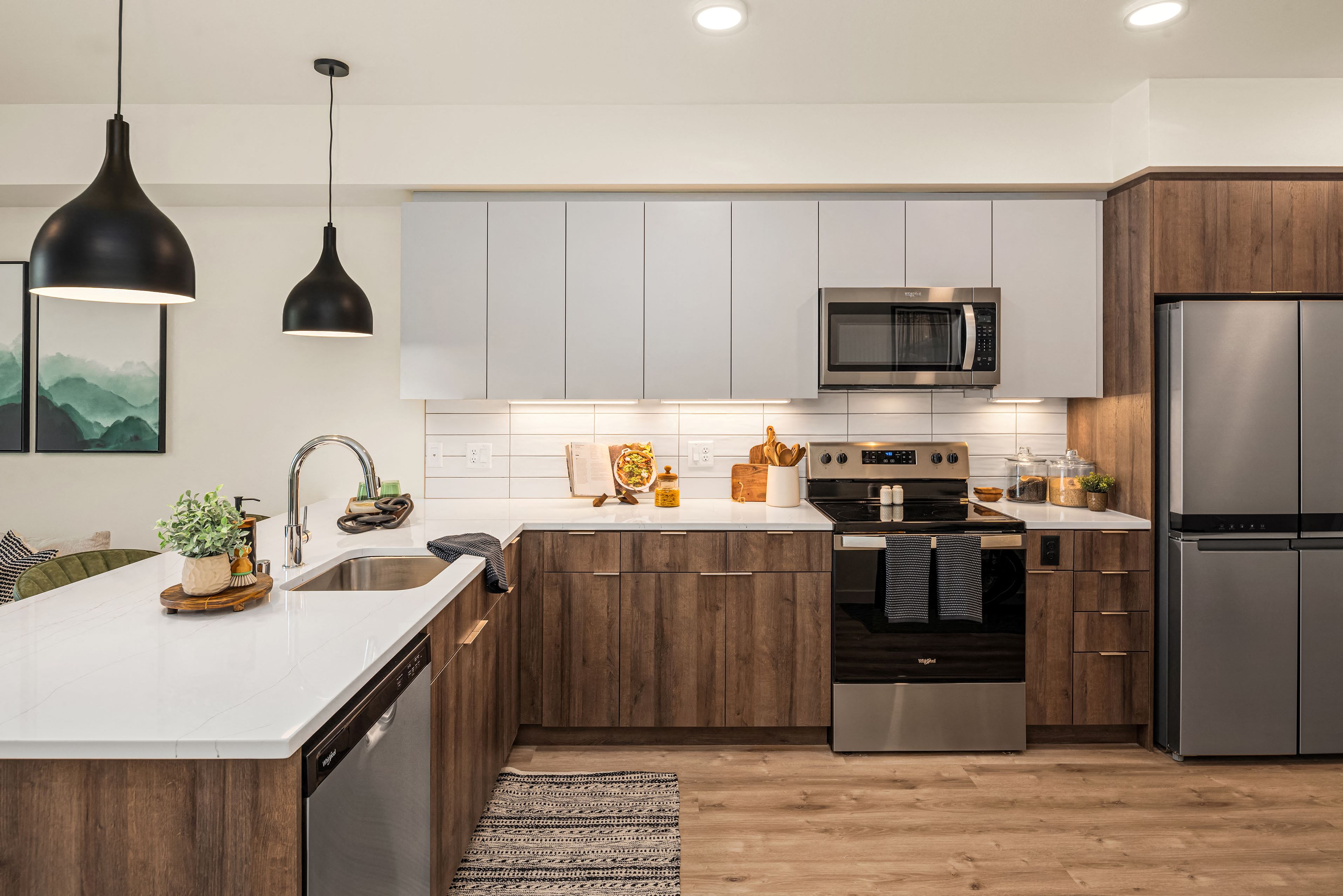 A modern kitchen with wooden cabinets and stainless steel appliances.