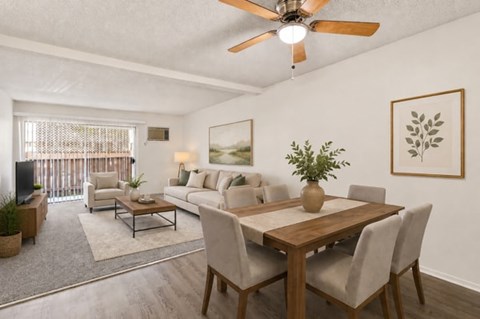 A dining room with a wooden table and chairs.