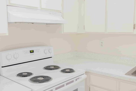 A white stove with four burners is in a kitchen.
