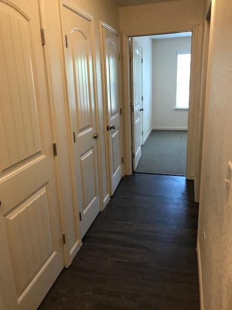 a hallway with wooden floors and white doors