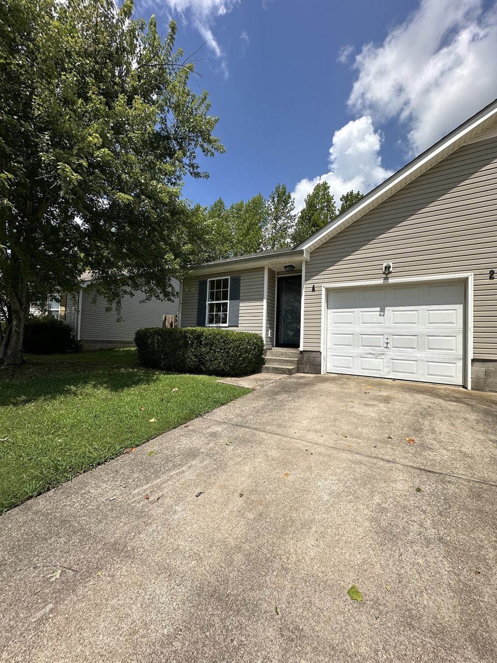 a white garage door on the side of a house