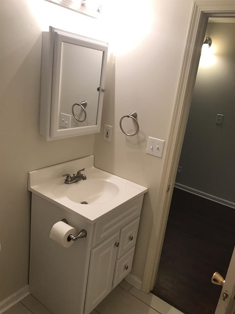 A white bathroom sink with a mirror above it.