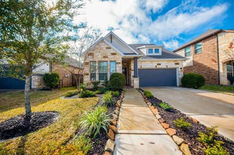 a house with a driveway and a garage door