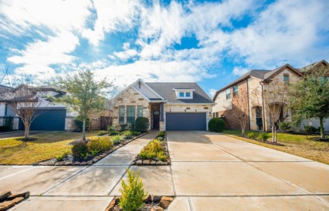 a house with a driveway and a garage door