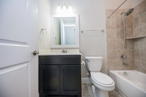 a bathroom with a toilet sink and a mirror