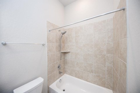 a bathroom with a shower and a toilet and a sink