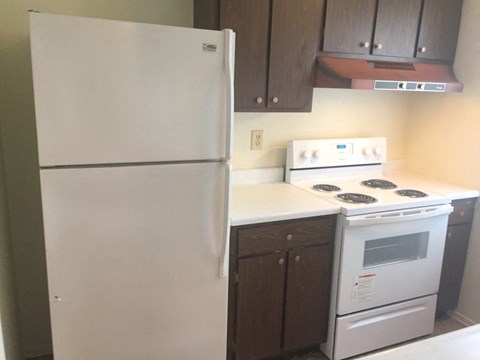 a kitchen with a white stove and a refrigerator