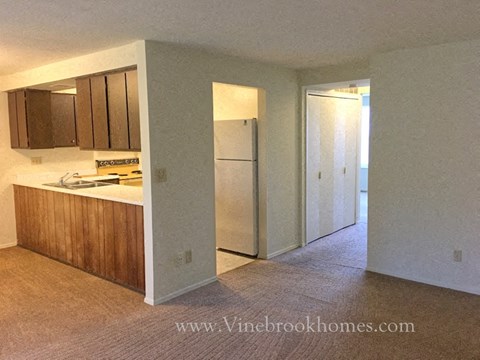 A kitchen with a refrigerator and a countertop.