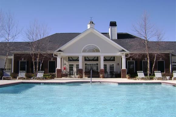 a large swimming pool in front of a house