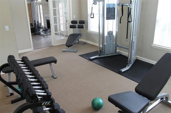 a gym with some weights and other equipment in it