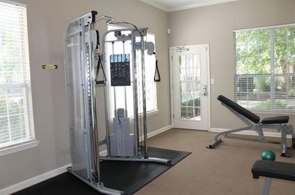 a fitness room with a treadmill and other equipment