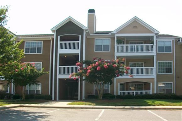 a large apartment building with roses in front of it