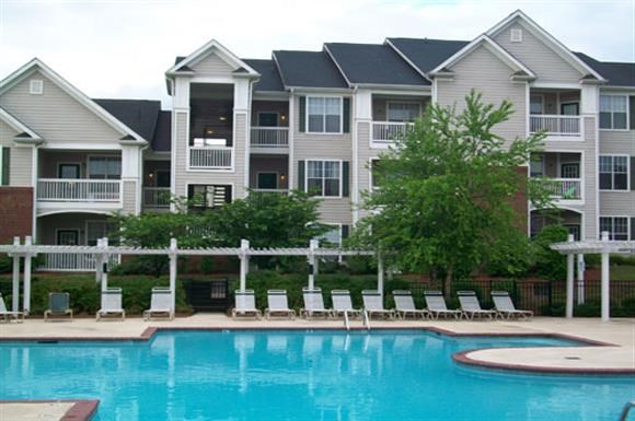 an apartment building with a large swimming pool