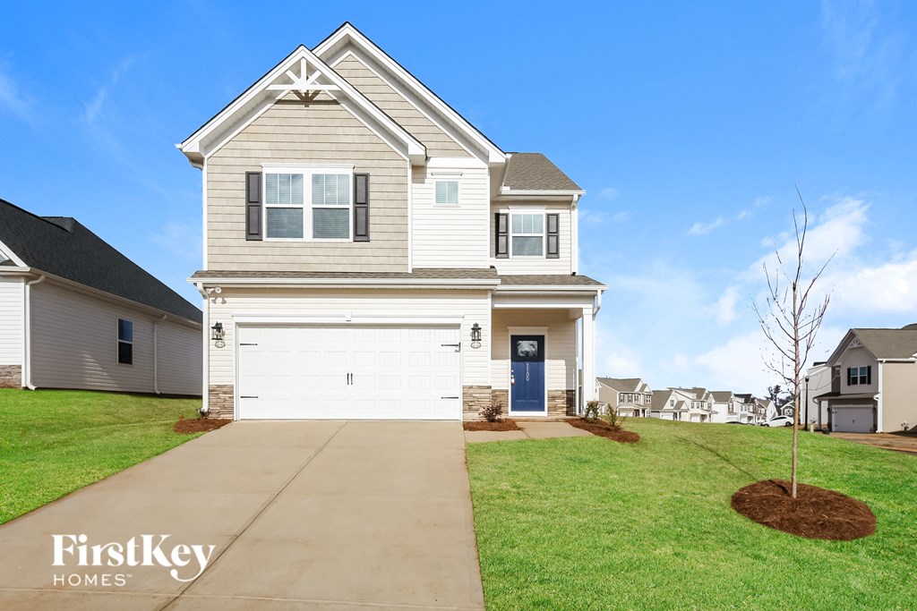 a white house with a white garage door and a green lawn