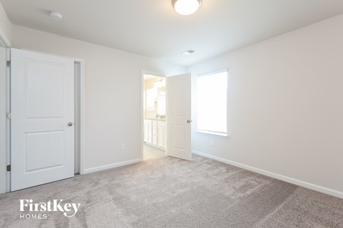 a bedroom with two closets and a door to a bathroom