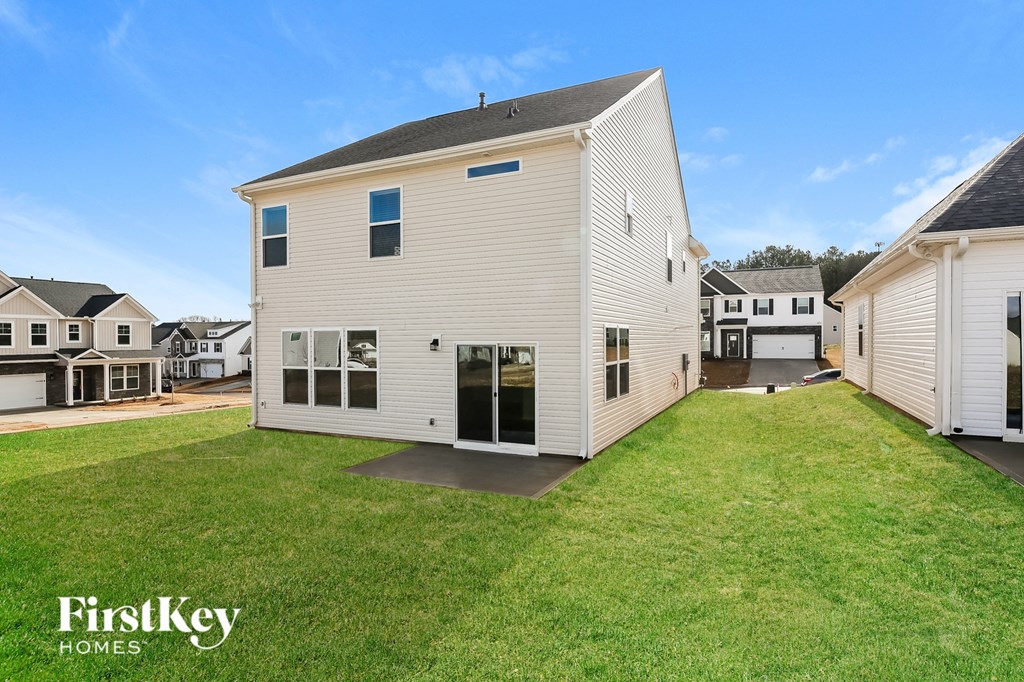 a white house with a yard in front of it