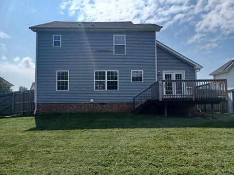 A house with a grey exterior and a deck.