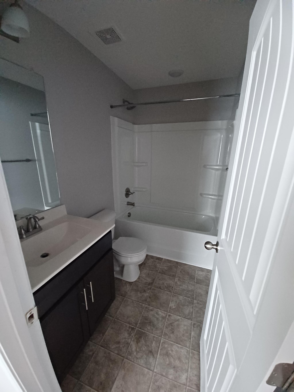 A bathroom with a toilet, sink, and shower.
