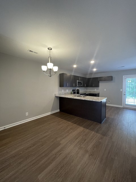 a view of a kitchen and living room in an empty home