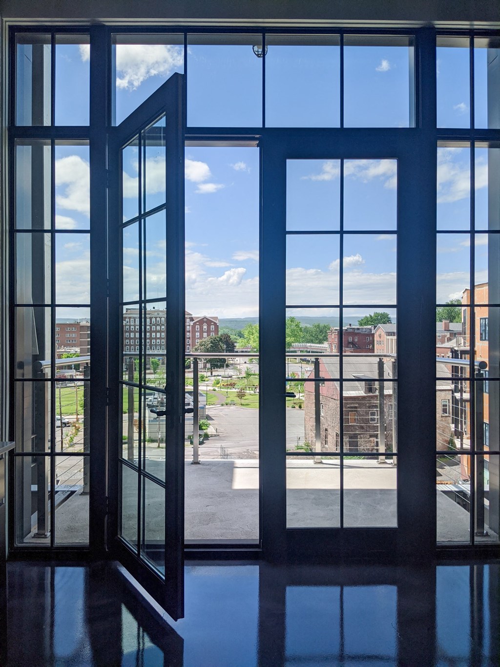 a view of the city from inside a building with large windows