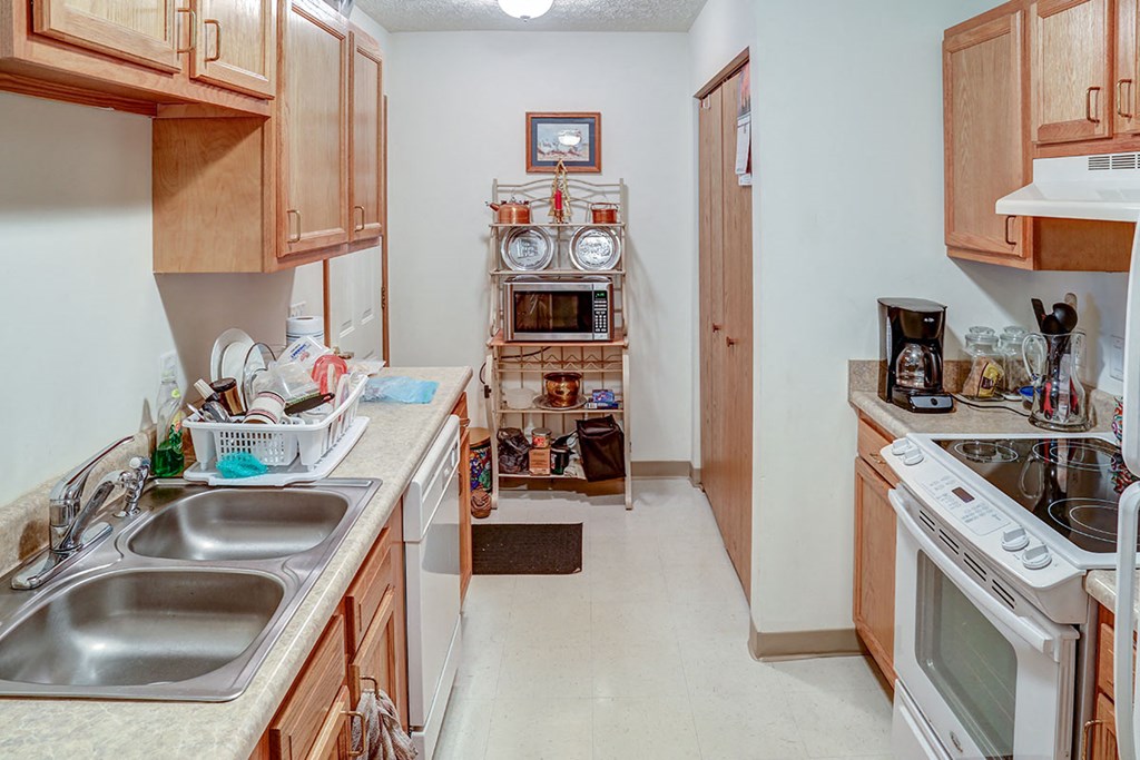 a kitchen with a sink and a stove and a refrigerator