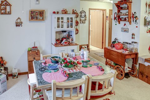a dining room with a table and chairs