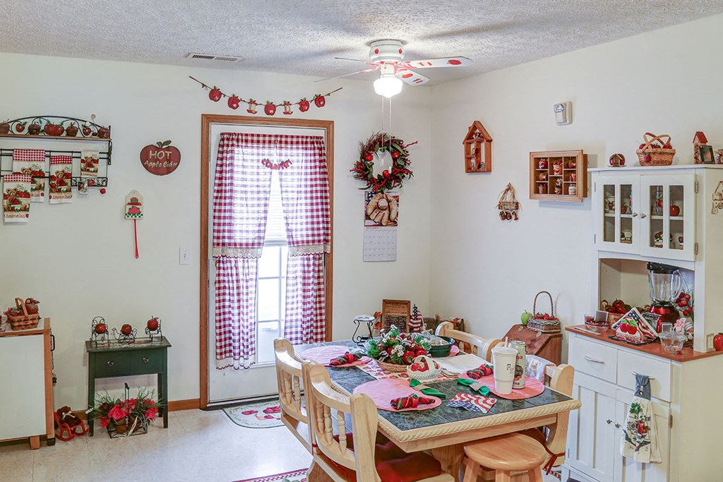 a dining room decorated for christmas with a table and chairs
