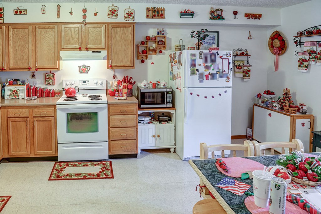 a kitchen with a stove refrigerator and a table