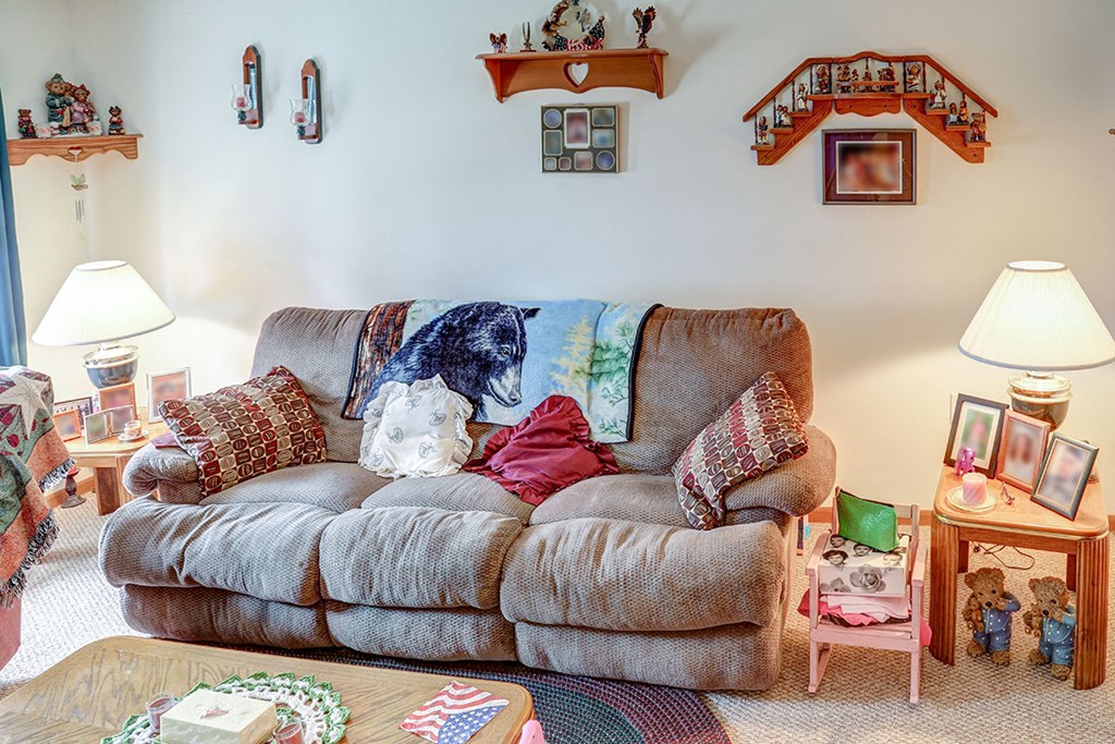 a living room with a couch with pillows on it