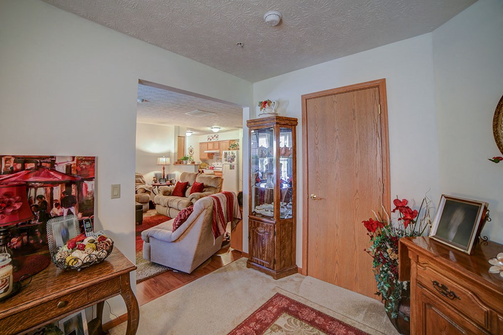 a living room with a couch and a door into a room