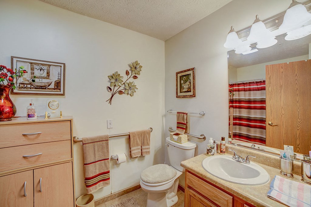 a bathroom with a sink toilet and a mirror