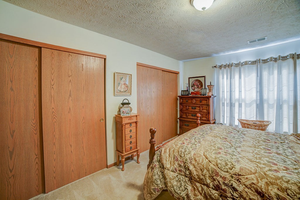 a bedroom with a bed and a dresser