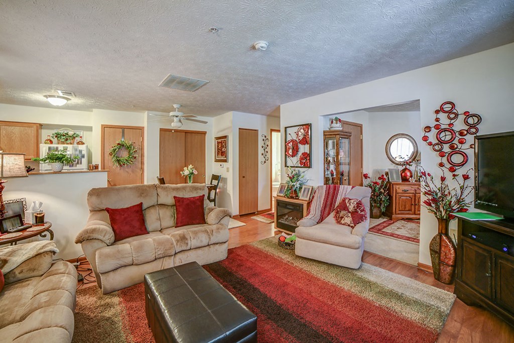 a living room filled with furniture and a tv