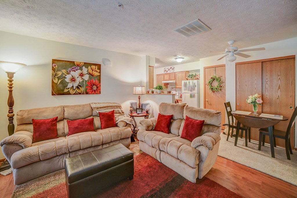 a living room with two couches and a dining room table