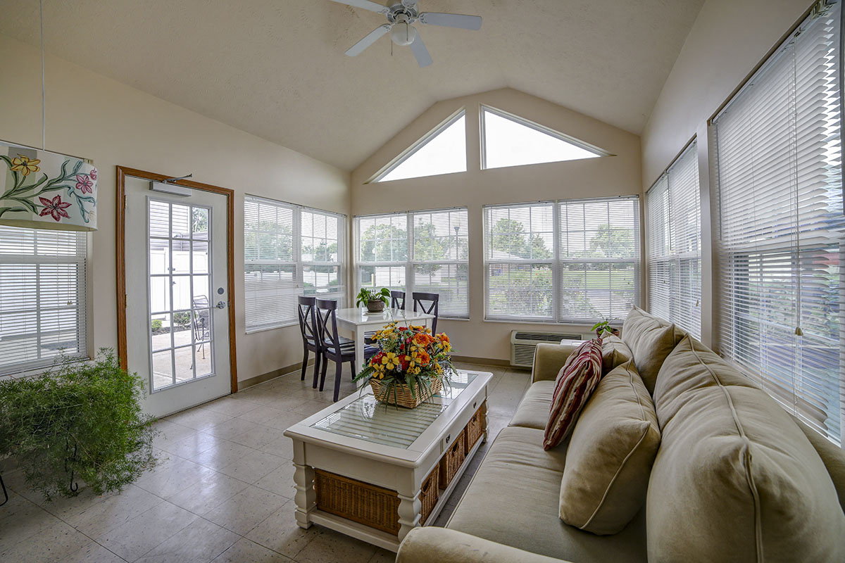 a large living room with a couch and a table