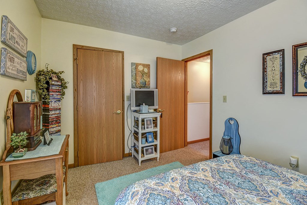 a bedroom with a bed and a tv       and a