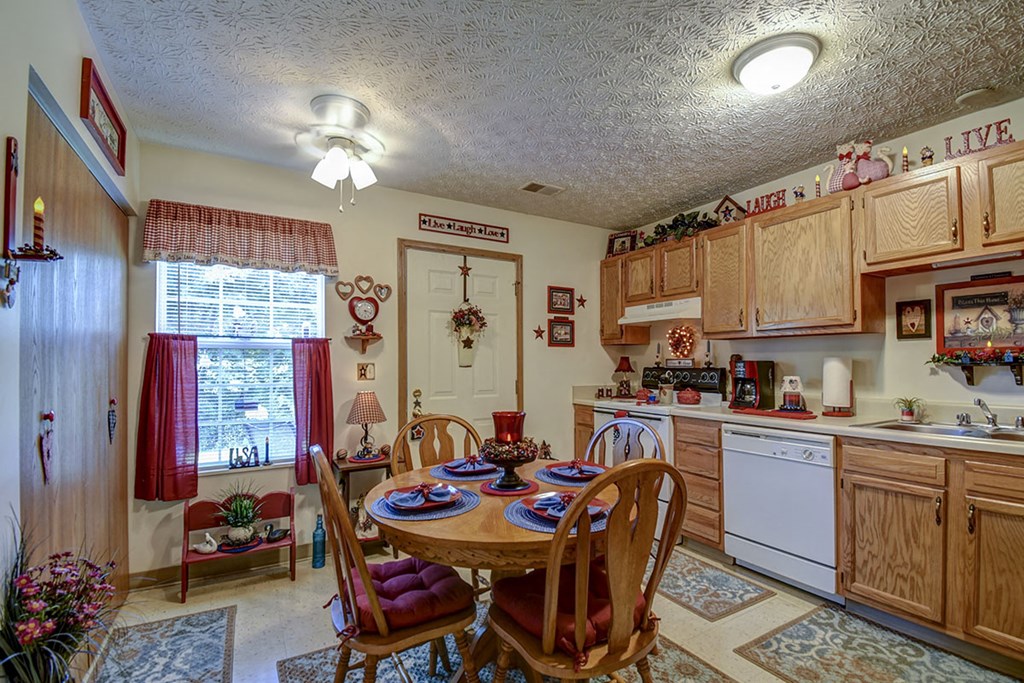 a kitchen and dining room with a table and chairs
