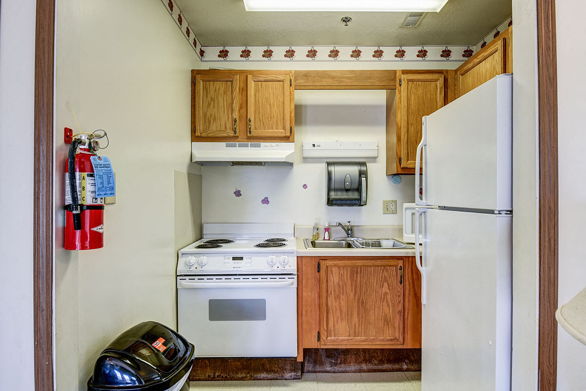 a kitchen with a stove refrigerator and a sink