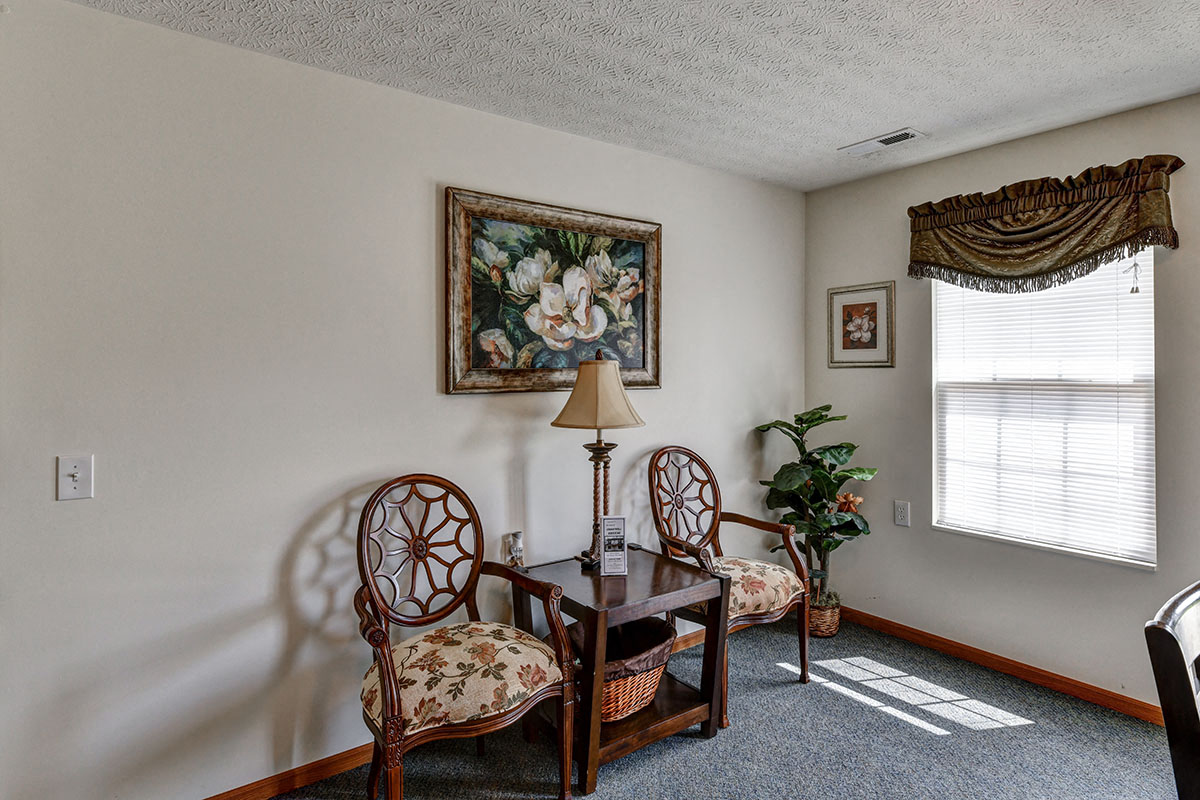 a living room with two chairs and a table