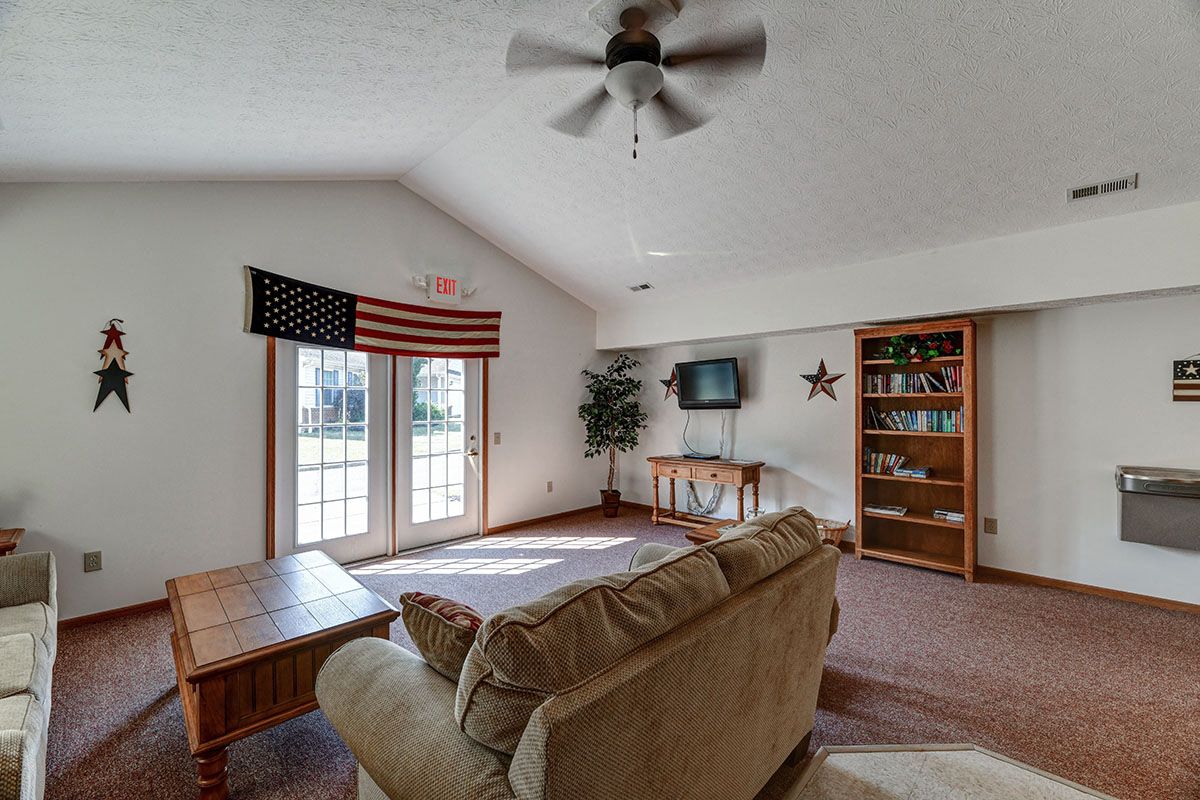 a living room with a couch and a ceiling fan