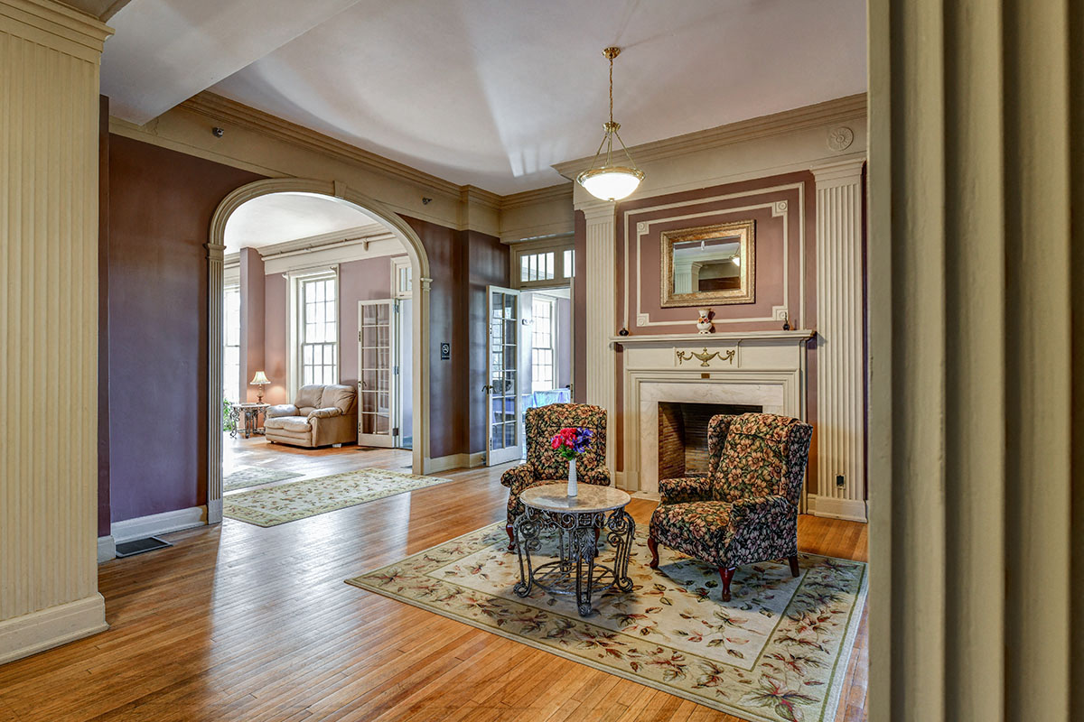 a living room with two chairs and a fireplace
