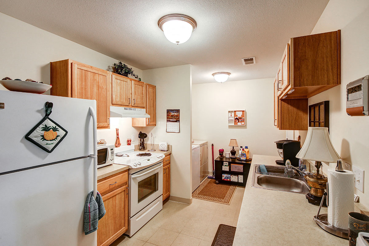 a kitchen with a stove refrigerator and a sink