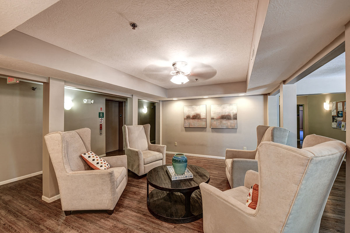 a living room with couches and chairs and a table