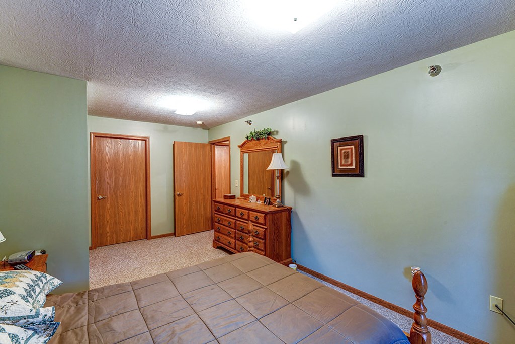 a bedroom with a bed and a dresser