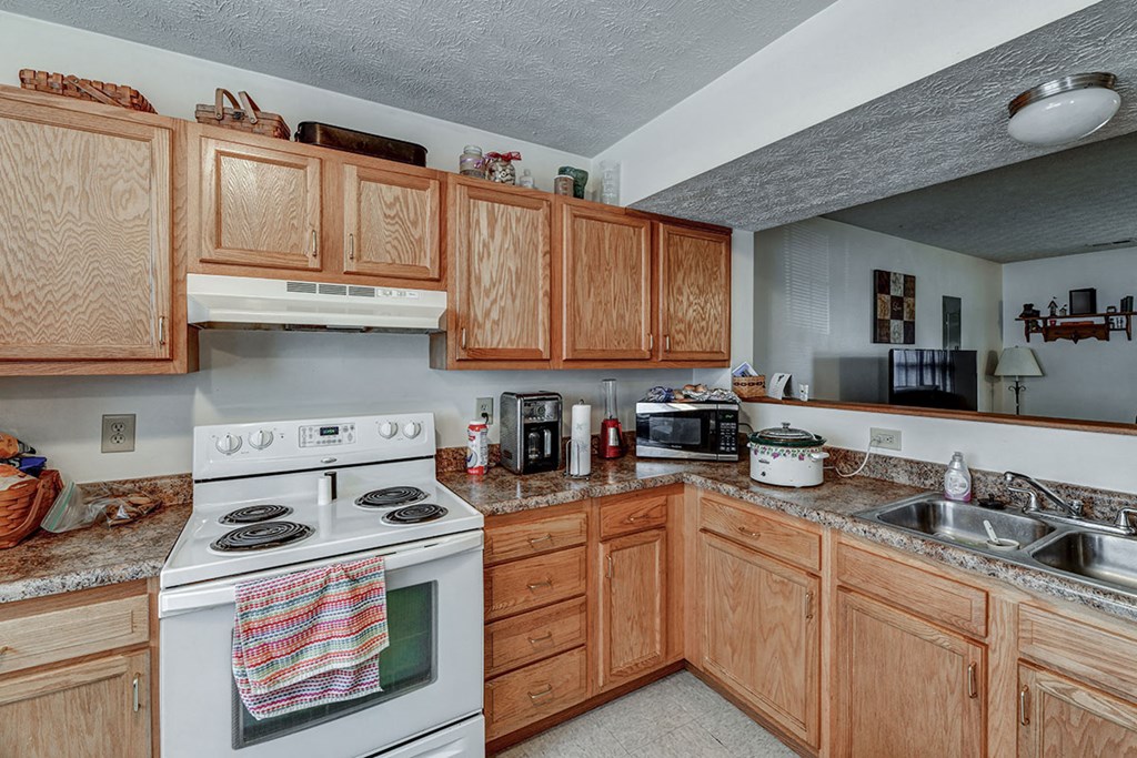 a kitchen with a stove oven and a sink